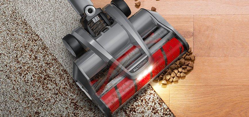 Close up of the Hoover emerge pet vacuum cleaner's dual brush roll in action, effectively cleaning both carpet and hardwood floor.
